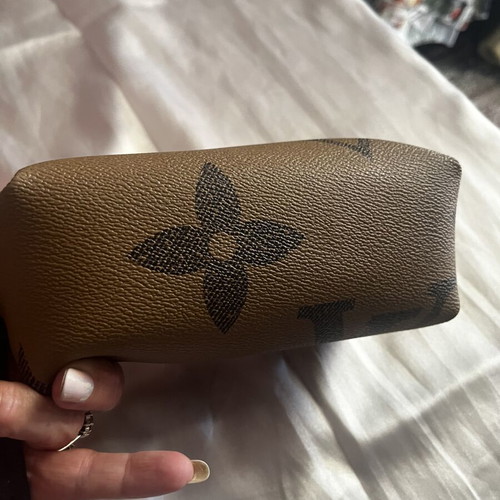Small toiletry bag like new, brown, with zipper and wrist strap