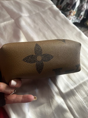 Small toiletry bag like new, brown, with zipper and wrist strap