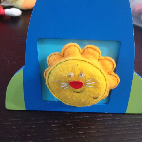 Handmade felt activity with lion in wooden frame used