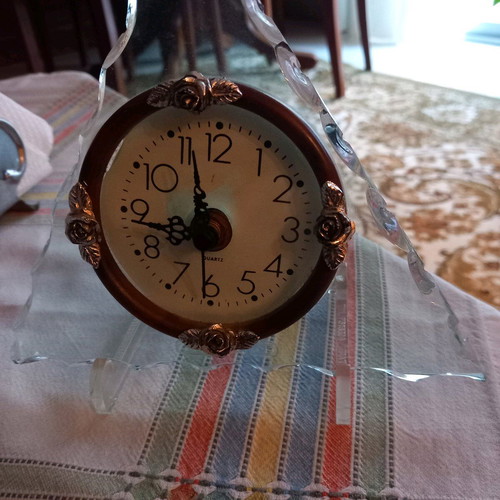 Decorative clock used, tabletop with wooden and glass base