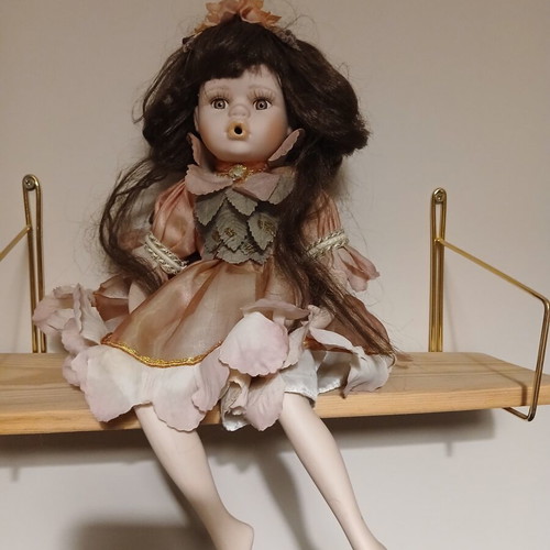 Porcelain doll sitting pose