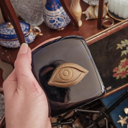 Decorative glass paperweight with metal eye like new