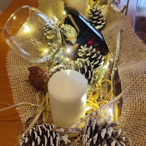 Christmas gift with wooden tray, wine bottle, glasses and decorations
