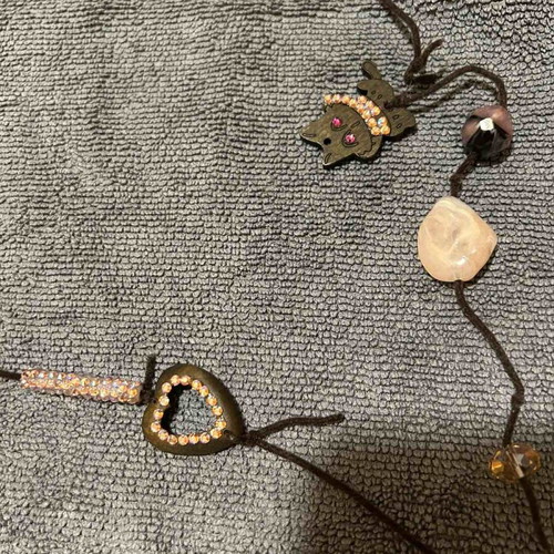Necklace with brown leather cord and pink beads used