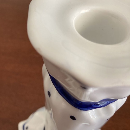 Vintage porcelain candlestick with blue bows and dots, used, damaged