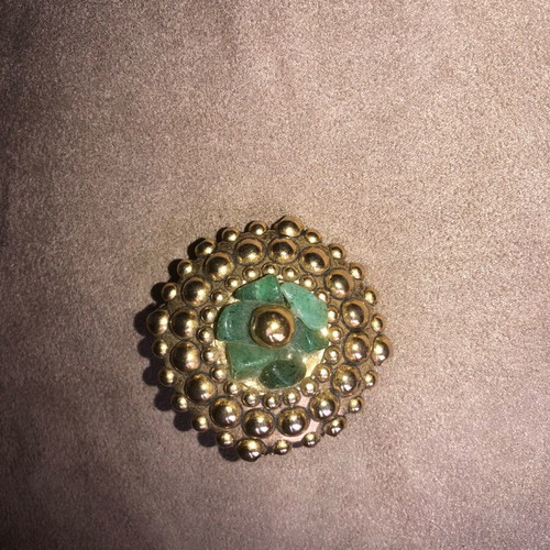 Vintage brooch like new with gold elements and green semi-precious stones