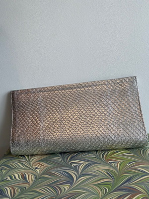 Silver clutch bag used, handheld