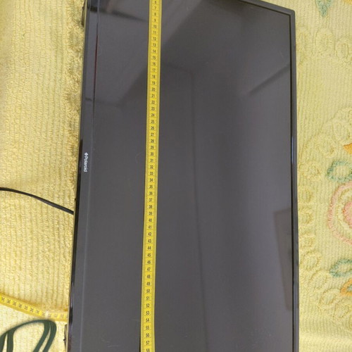 Polaroid TV used with wall mount, 61 cm width, 35 cm height