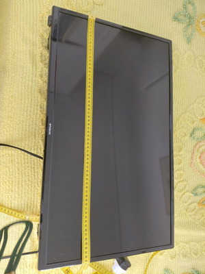 Polaroid TV used with wall mount, 61 cm width, 35 cm height