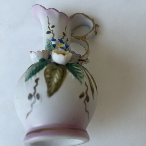 Vintage ceramic pitcher with embossed flowers used