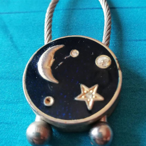 Keychain with moon and star design used, blue and silver