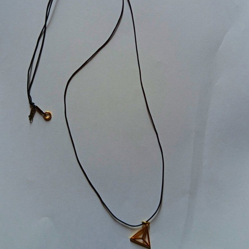 Necklace with gold charm used, black cord