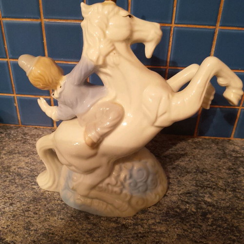 Vintage ceramic clown figurine riding a unicorn used