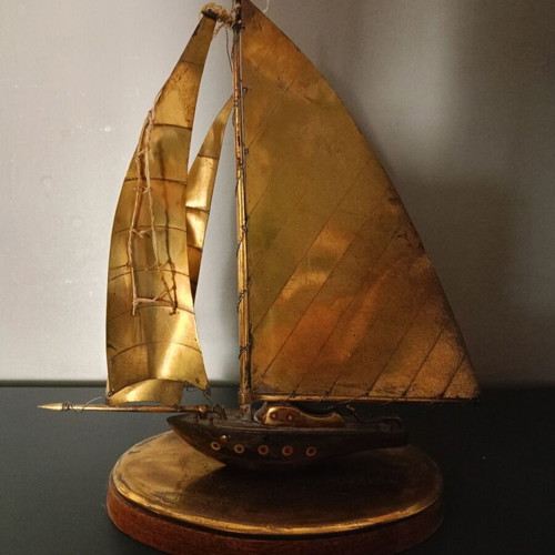 Vintage brass sailboat sculpture on wooden base, used