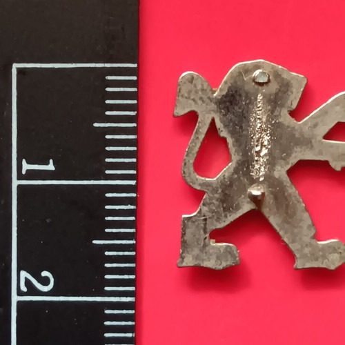 Small metal lion badge used