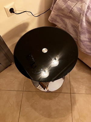 Round coffee table with glass top and magazine holder like new