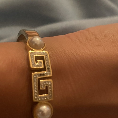Steel bracelet used, gold color with meander design, crystals and pearls