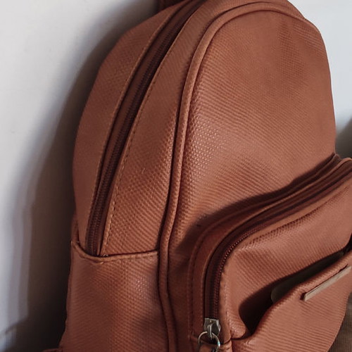 Back pack tan used with internal and external pockets