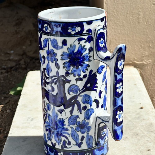 Vintage handmade ceramic cup and decorative Delft style jug used, blue floral