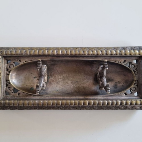 Vintage metal pen tray used with embossed floral motifs and dolphin supports