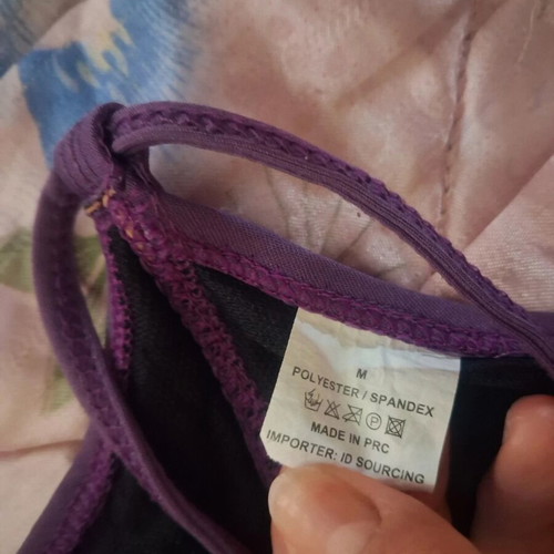 One-piece swimsuit used, purple with cut-outs and adjustable ties, size M