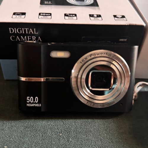 Digital camera used with velvet case, cable, battery, and strap