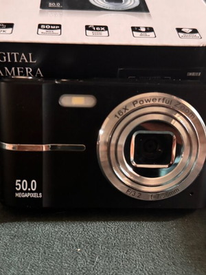 Digital camera used with velvet case, cable, battery, and strap
