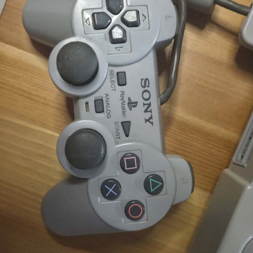 Sony PlayStation 1 console used with memory card, controller, and game