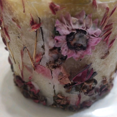 Decorative candle with dried flowers used