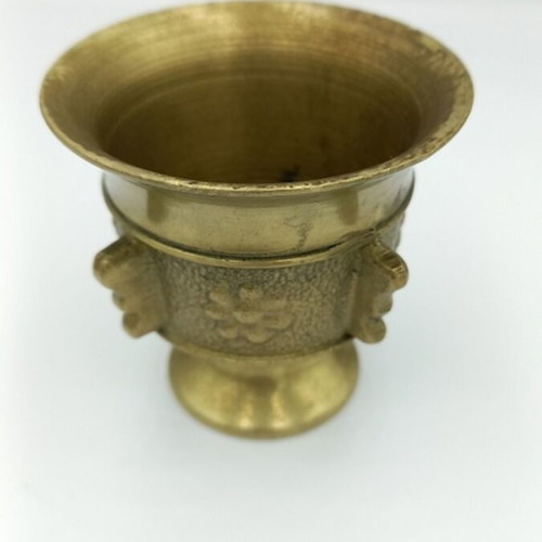 Metal mortar used with face and plant decoration