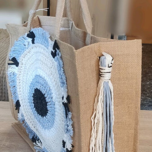 Jute bag with knitted decorative eye and waterproof lining