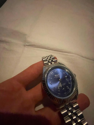 Seiko watch with blue dial and silver bracelet