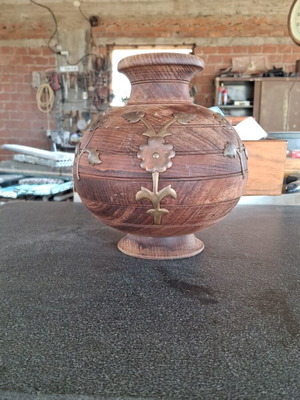 Wooden flowerpot decorated with brass used