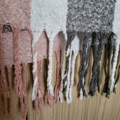 Winter scarf used in pink and gray shades with fringes
