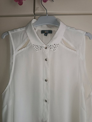 Sleeveless white shirt with studs on collar used