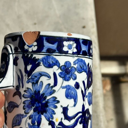 Vintage handmade ceramic cup and decorative Delft style jug used, blue floral