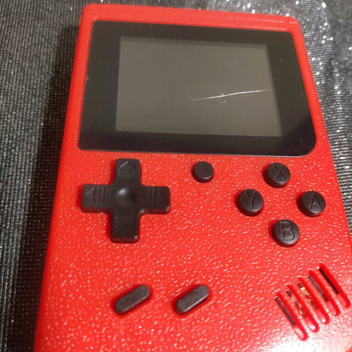 Retro style handheld game console used, working