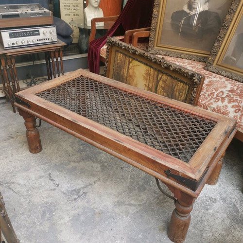 Vintage wooden coffee table used with industrial metal mesh design