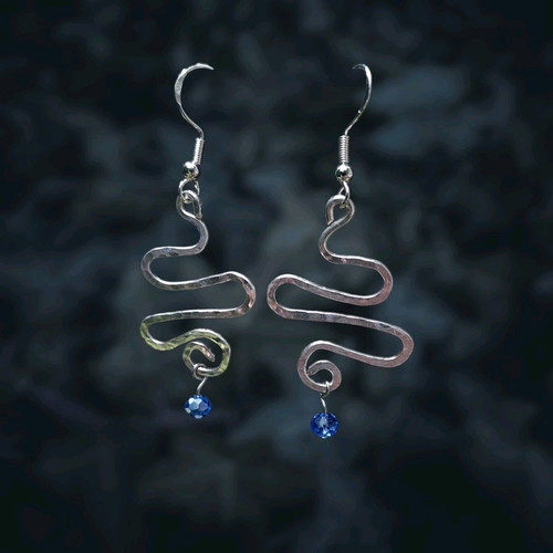 Swirly silver earrings with light blue crystal new