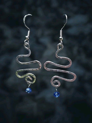 Swirly silver earrings with light blue crystal new