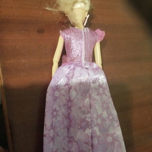 Doll with pink earrings and articulated joints used