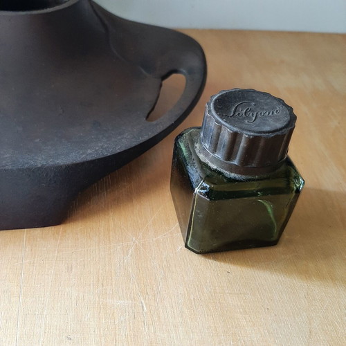 Vintage metal inkwell with ink bottle used