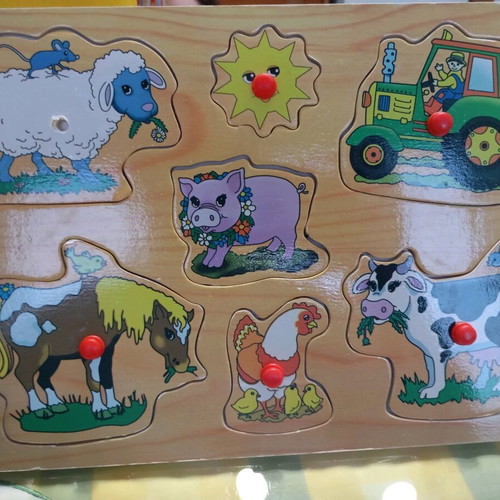 Wooden puzzle used with farm theme, missing one peg