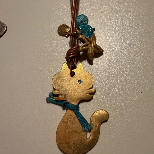 Cat design necklace like new, double brown leather cord with blue beads