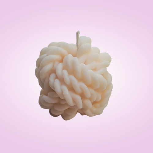 Soy wax candle in knitted skein shape with vanilla praline scent