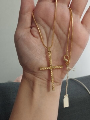 Gold-colored cross necklace with rhinestones