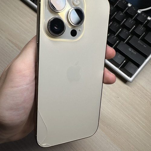 iPhone 14 Pro 128GB used, gold, with two cases, minor back crack