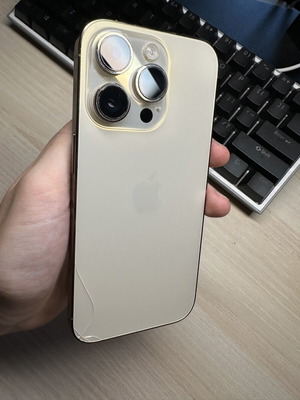 iPhone 14 Pro 128GB used, gold, with two cases, minor back crack