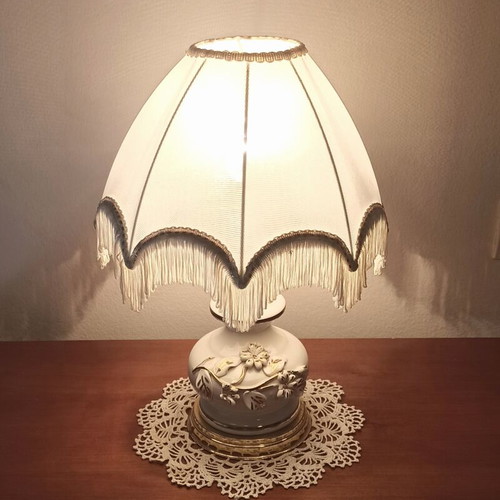 Vintage porcelain table lamp with fabric white shade and fringes used