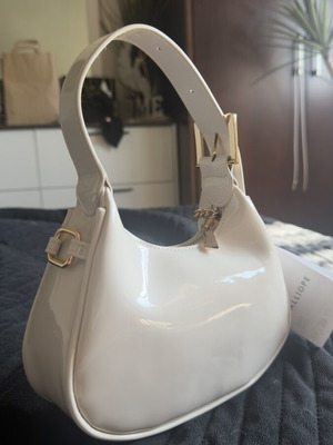 Small beige patent leather handbag in very light shade, new